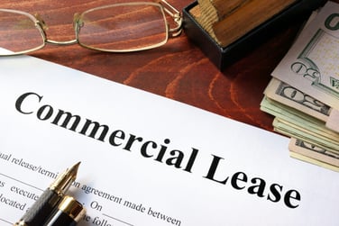 A lease agreement for commercial property on a table next to cash