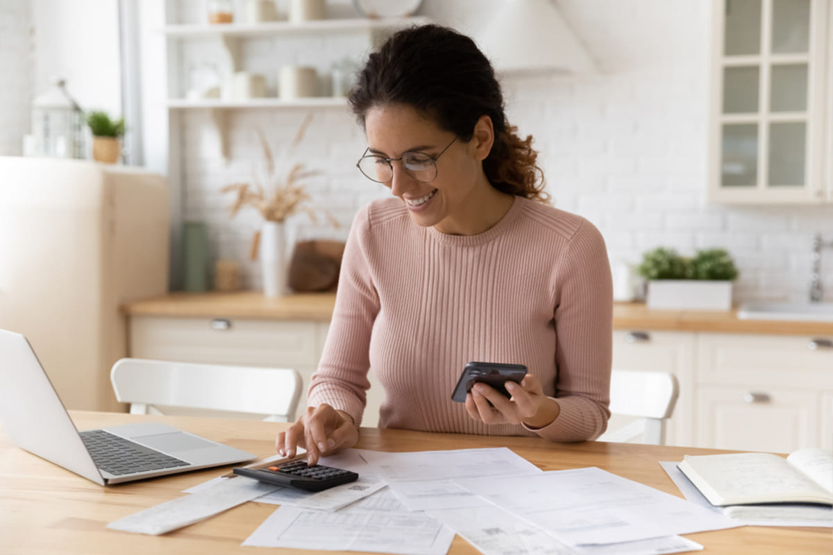 A woman typing on a calculator