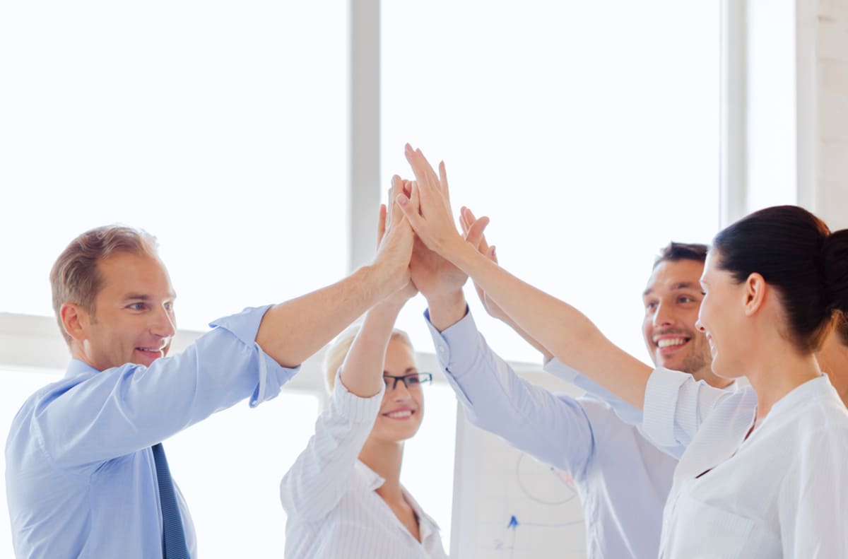 Business people giving high fives, partnership property management success concept