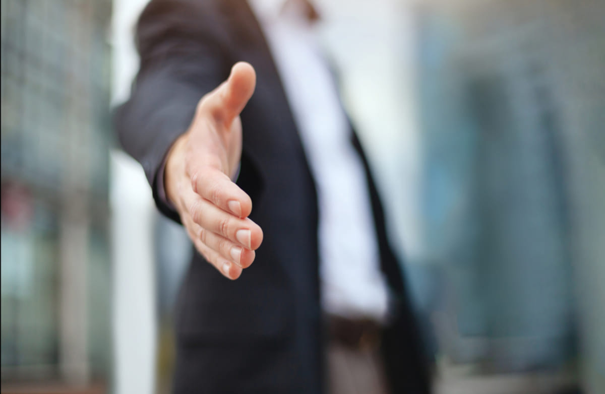 Businessman offers hand as a business agreement proposal