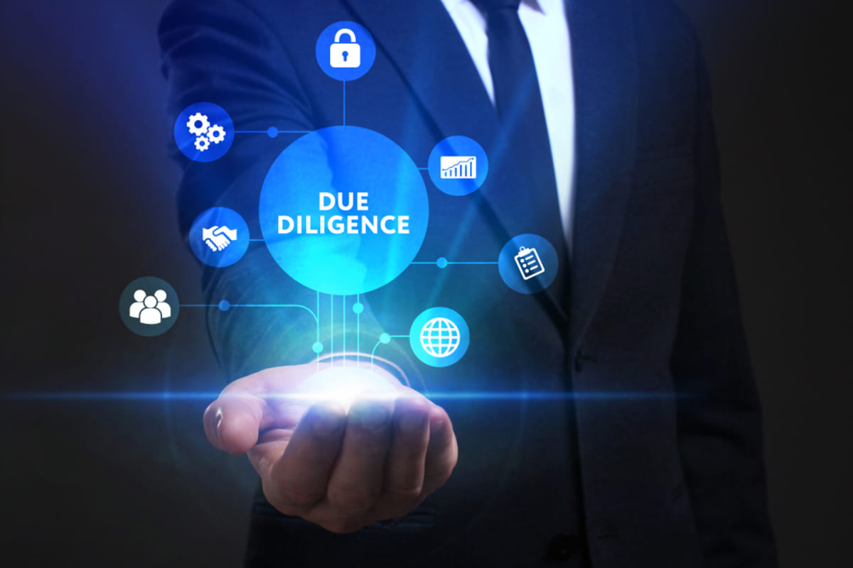 Businessman working on virtual screen sees the inscription Due diligence