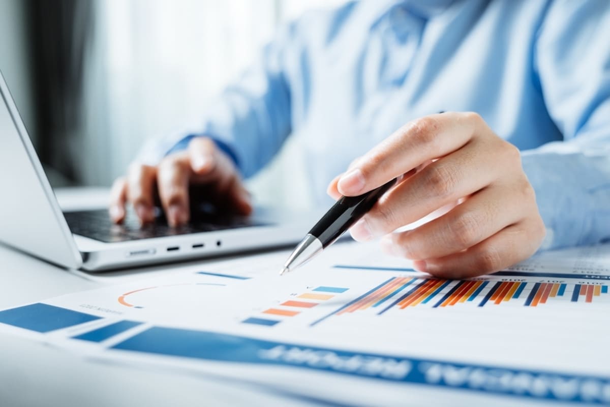 Close-up of business person reviewing reports, communicating with investors concept