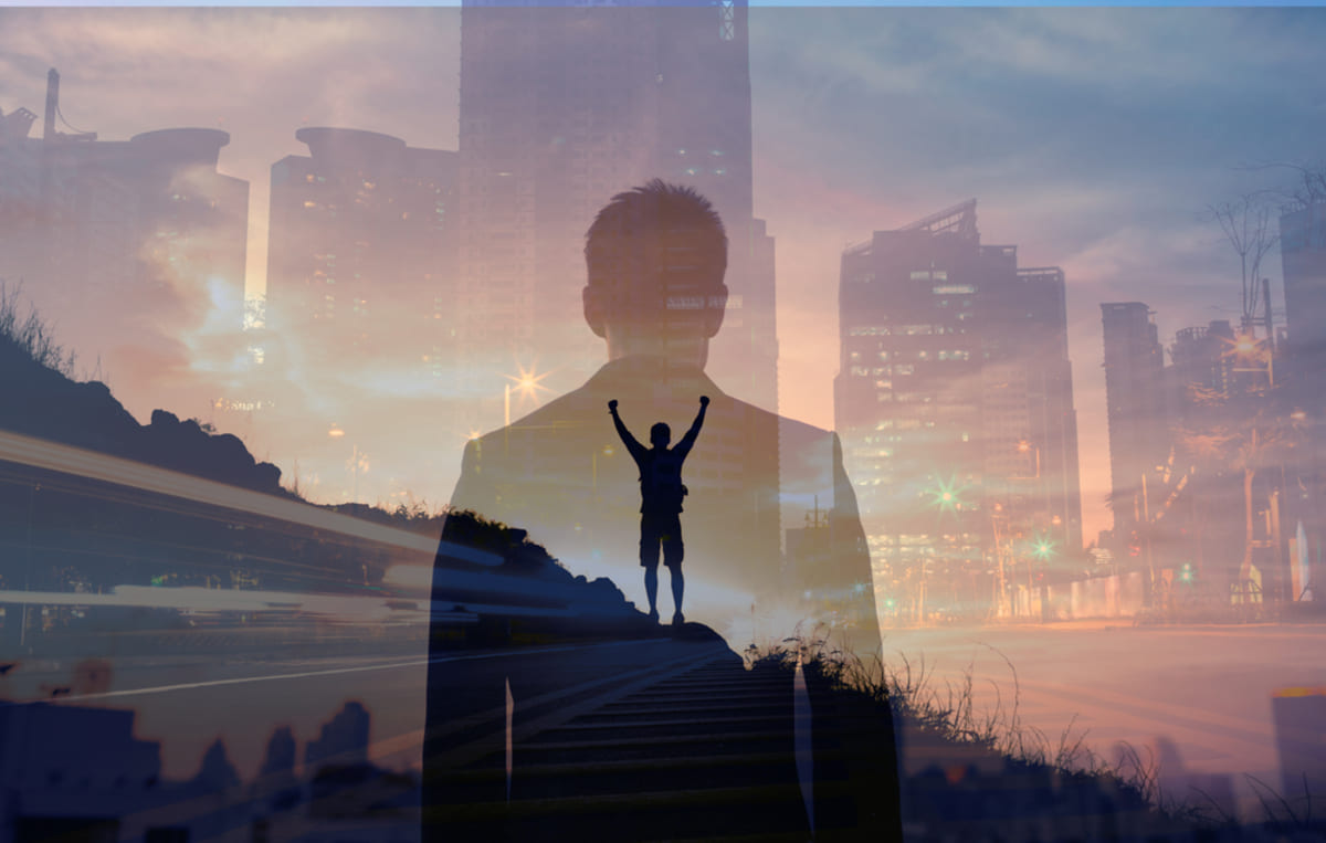 Confident young businessman in front of city view