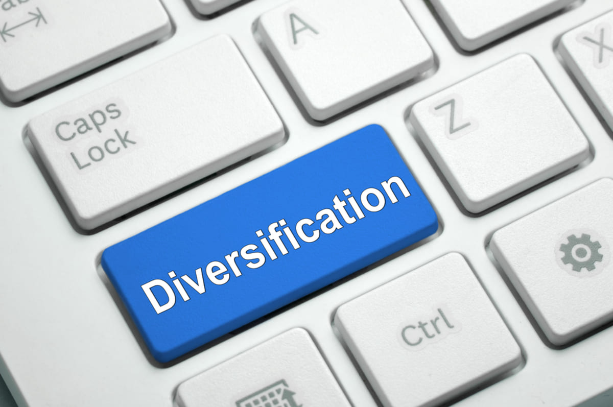 Diversification text written on blue button white keyboard