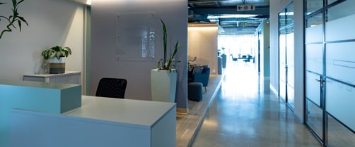Empty chair at reception counter in modern illuminated office