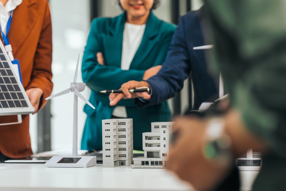 Group of people looking at models of commercial buildings (1)