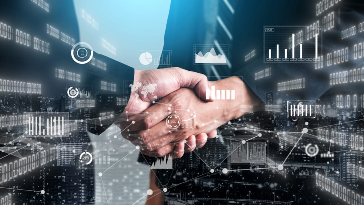 Handshake for business visual with computerized investment data graph