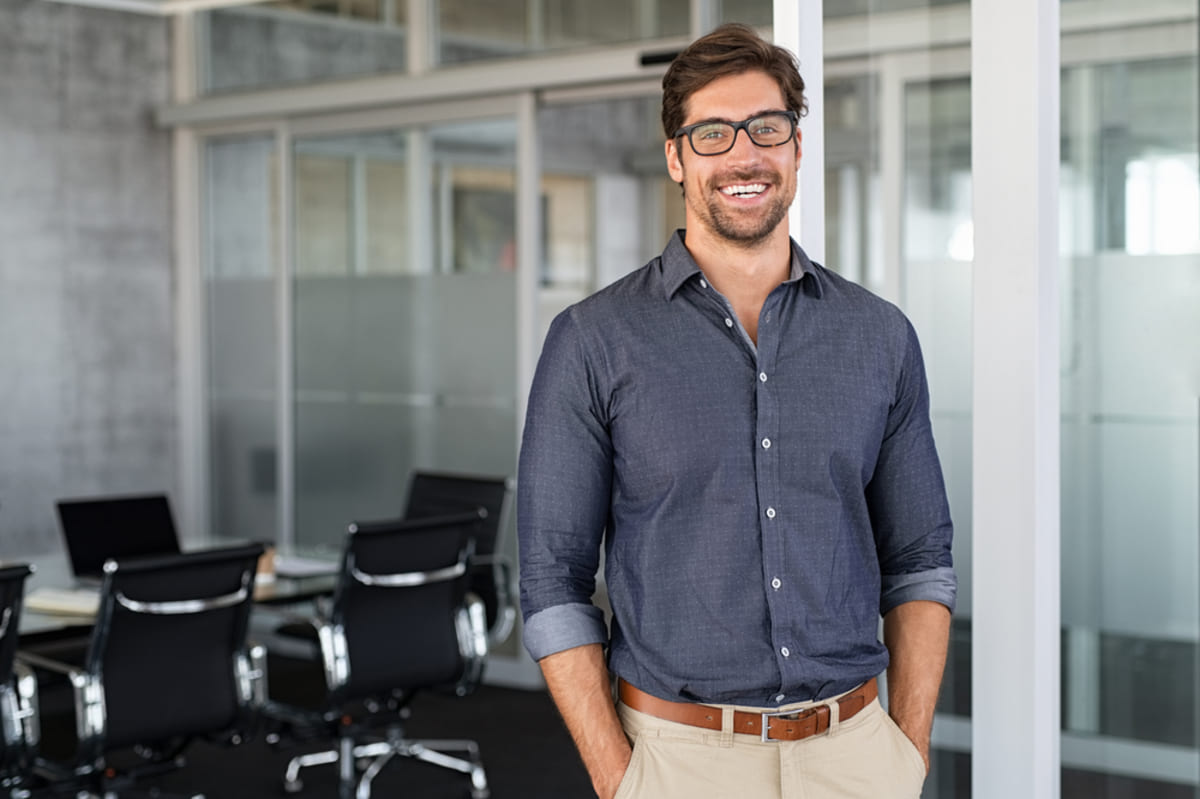Happy businessman in office, tenant satisfaction concept