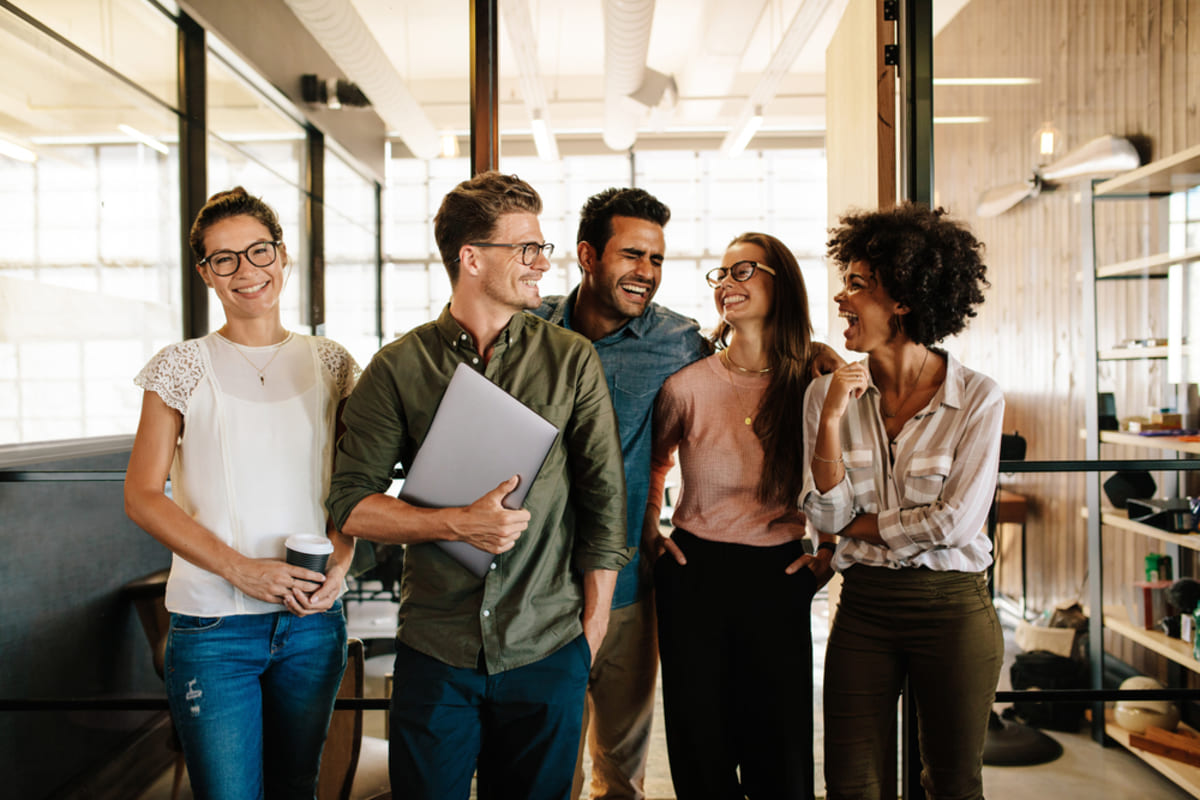 Happy people in an office space, working with Kenwood Management Company