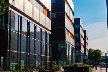 This image features the exterior of a commercial real estate office building. 
