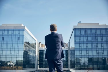 Businessman outside looking at commercial office buildings