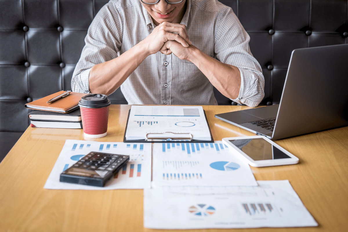 Investor looking happily at graphs on his desk
