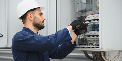 Maintenance worker doing electrical repairs at a commercial property