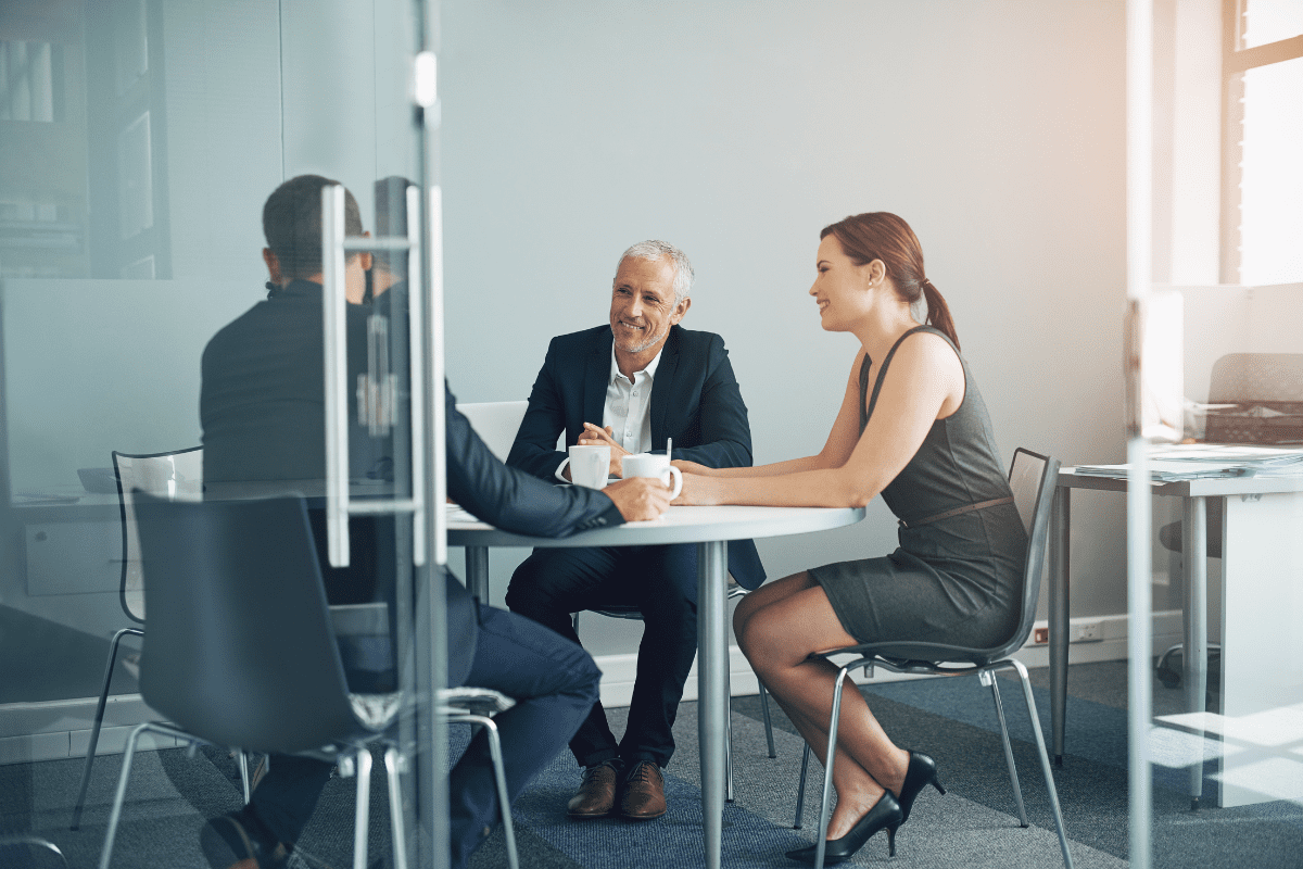 Small business meeting happening behind open crystal door
