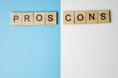 The words pros and cons in block letter