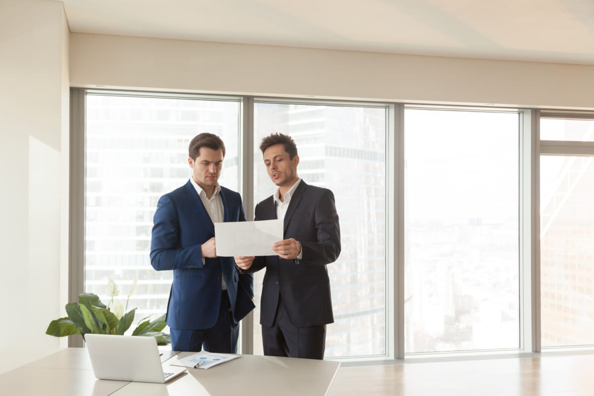 Two businessmen talking exemplifying  working with Kenwood Property Management
