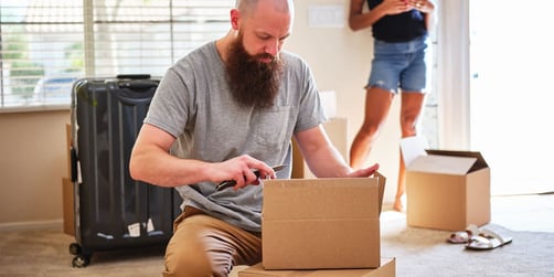 Two people packing up boxes and moving out of an apartment