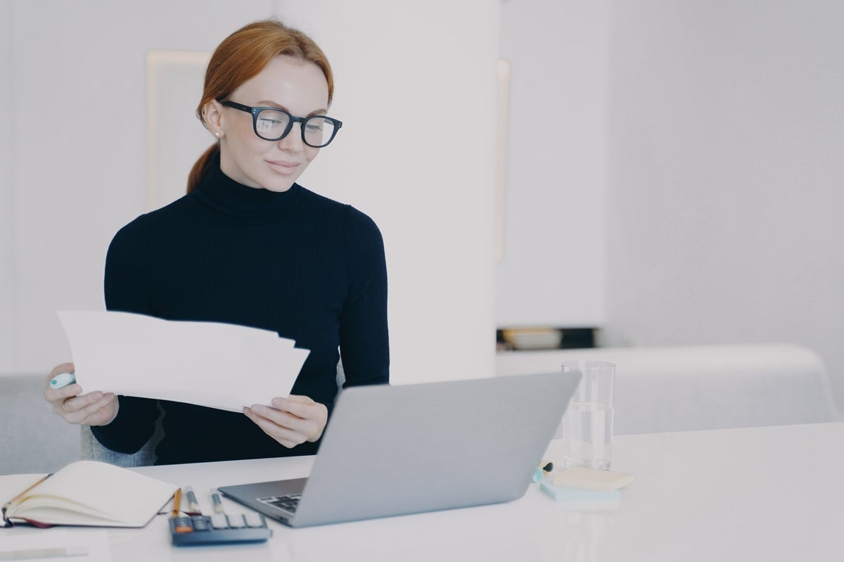 Woman reviewing real estate market on Laptop