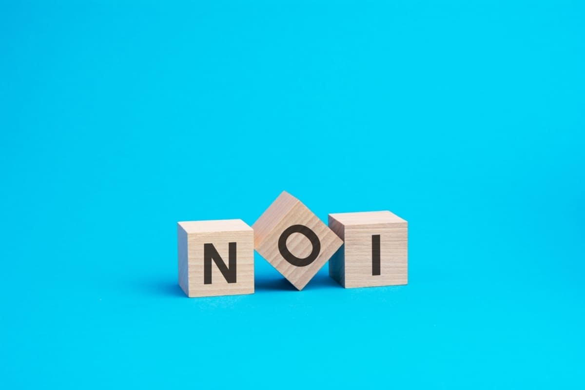 Wooden blocks that say NOI, evaluating commercial real estate Washington DC