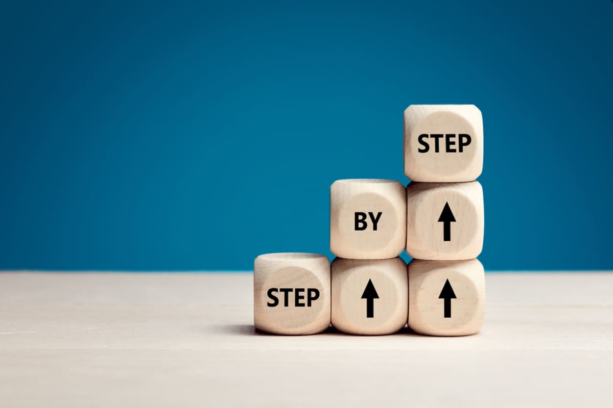 Wooden cubes with the words step by step on them