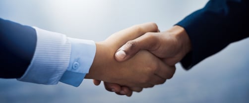 businesspeople shaking hands in an office