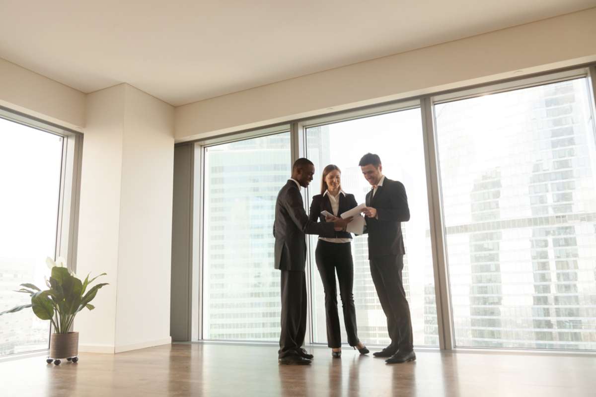 Business people reviewing documents in an empty multi-tenant property.