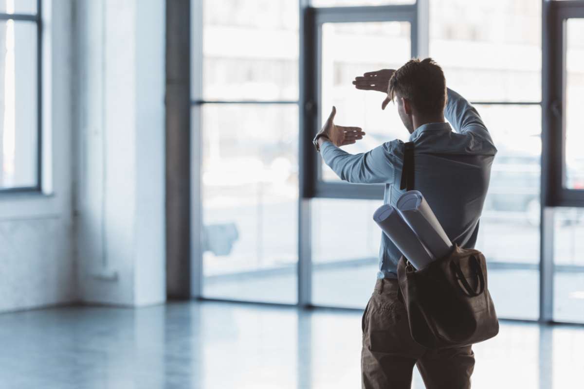 Businessman looking at an empty commercial space for a business rental space.