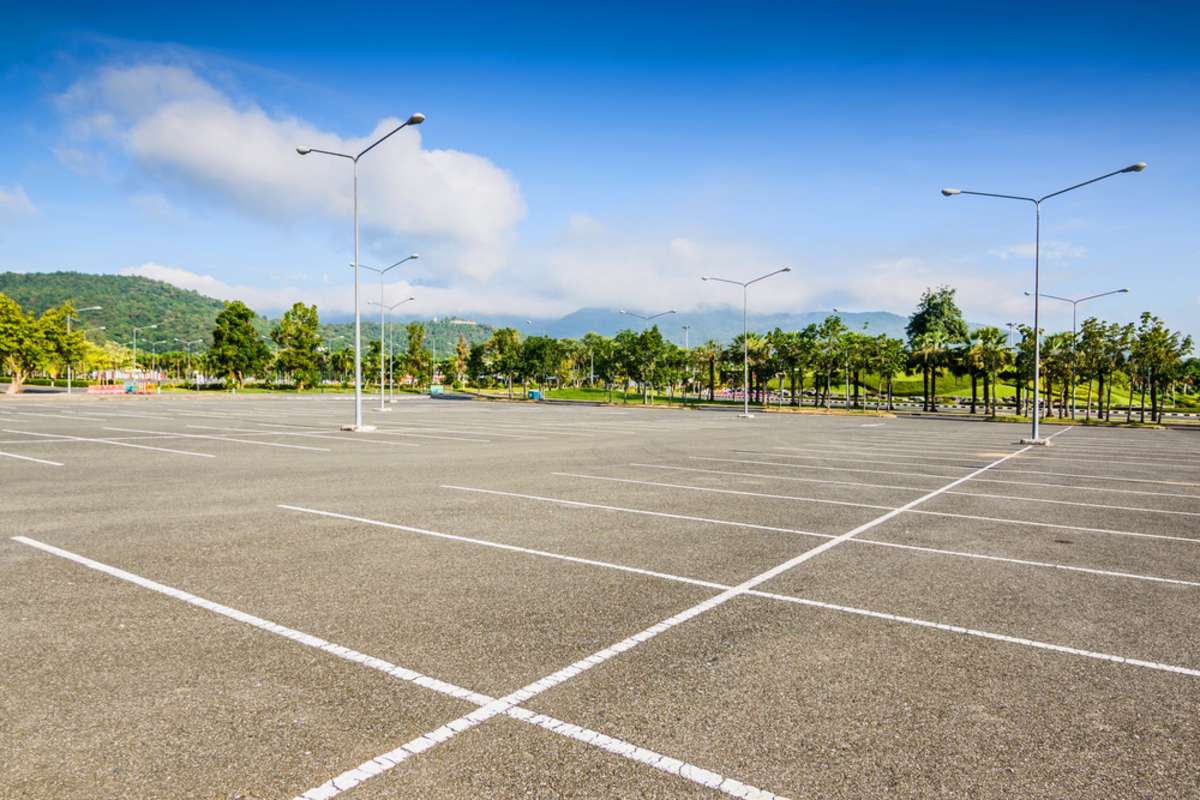 Empty parking lot, choosing commercial building for lease concept