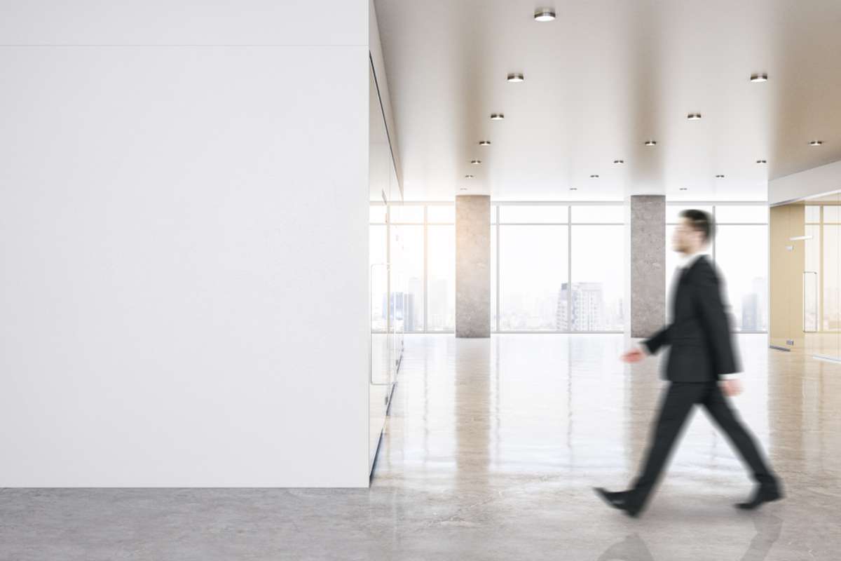 Man walking in office building, foot traffic, lease retail space concept