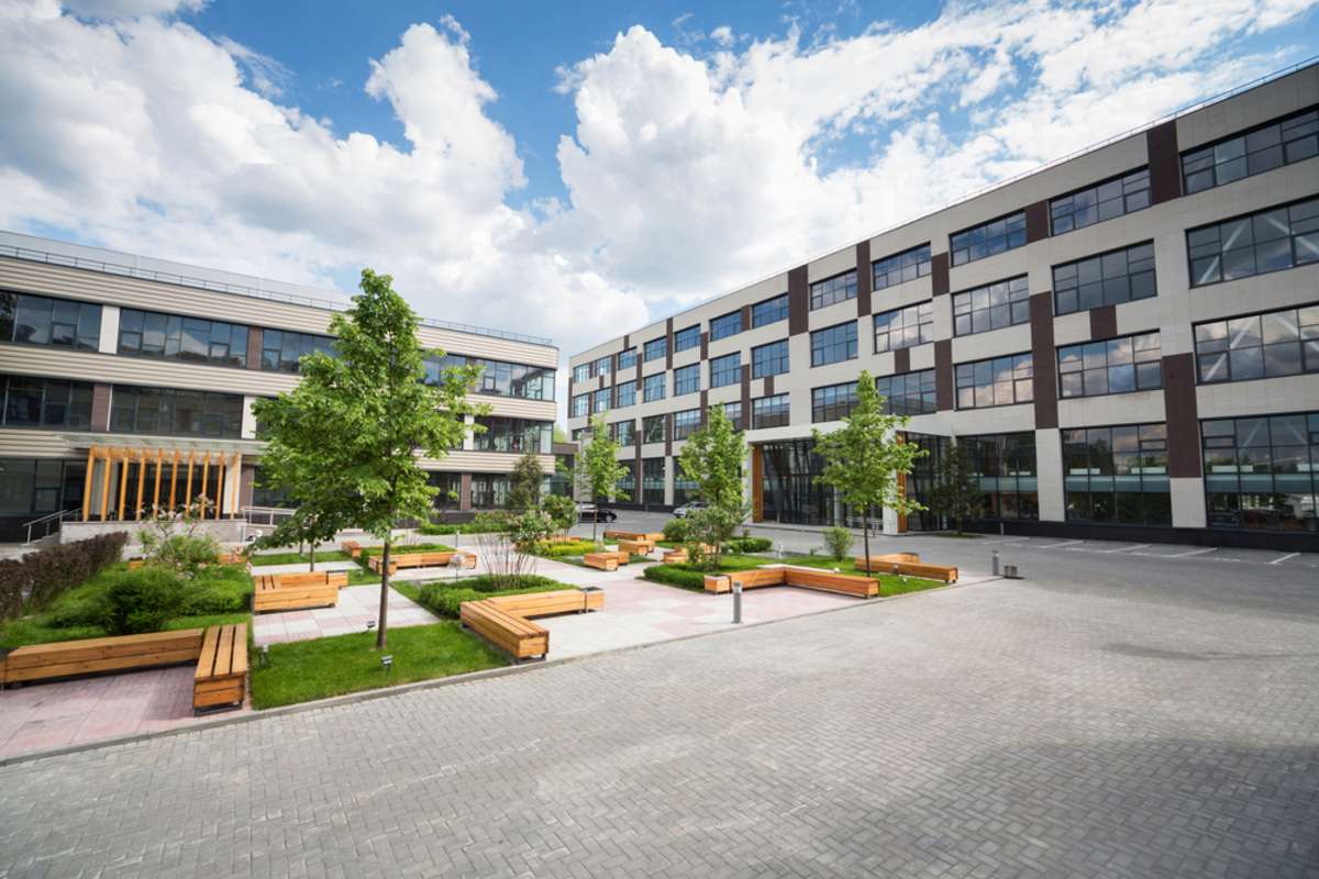 Trees and benches in front of office building, commercial real estate Baltimore, MD, concept