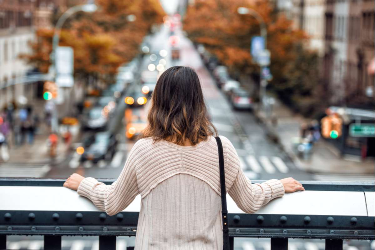 Woman overlooking a busy street, Baltimore commercial real estate concept