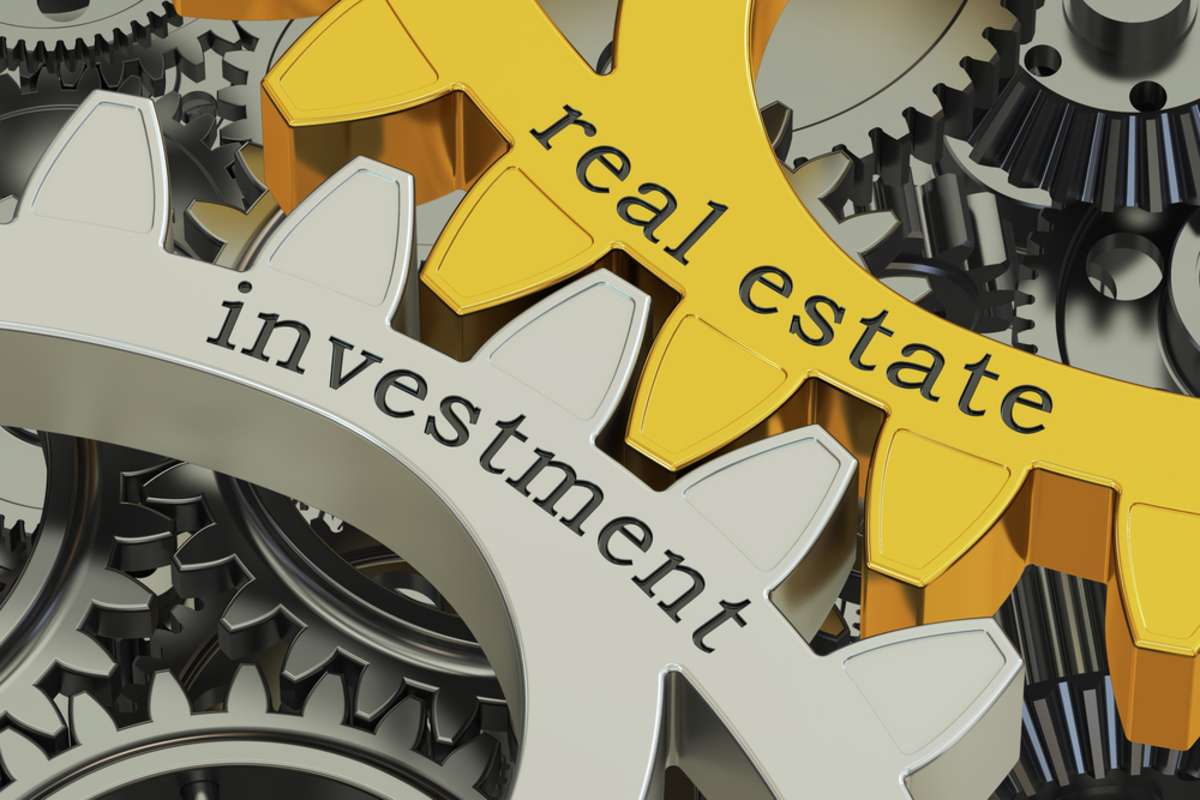 real estate investment concept on the gearwheels