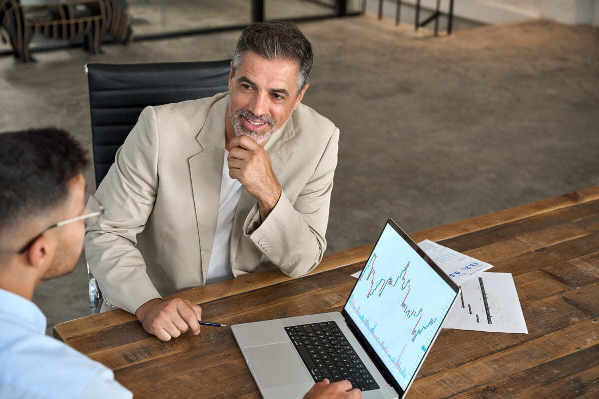Two businessmen having a meeting with a chart.