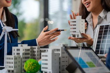 Two people talking with commercial real estate models.