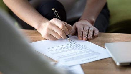 Close-up of signing a commercial lease agreement.