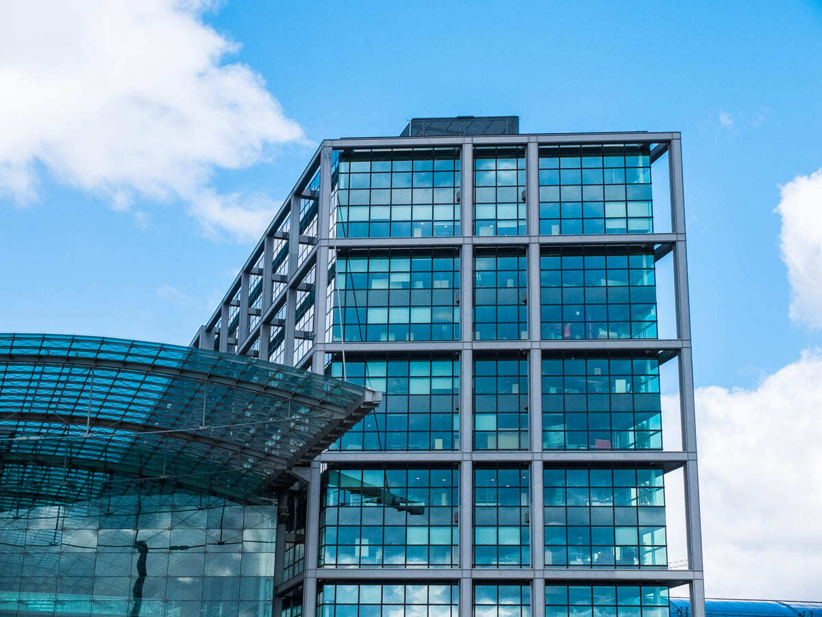 A modern commercial office building against a blue sky