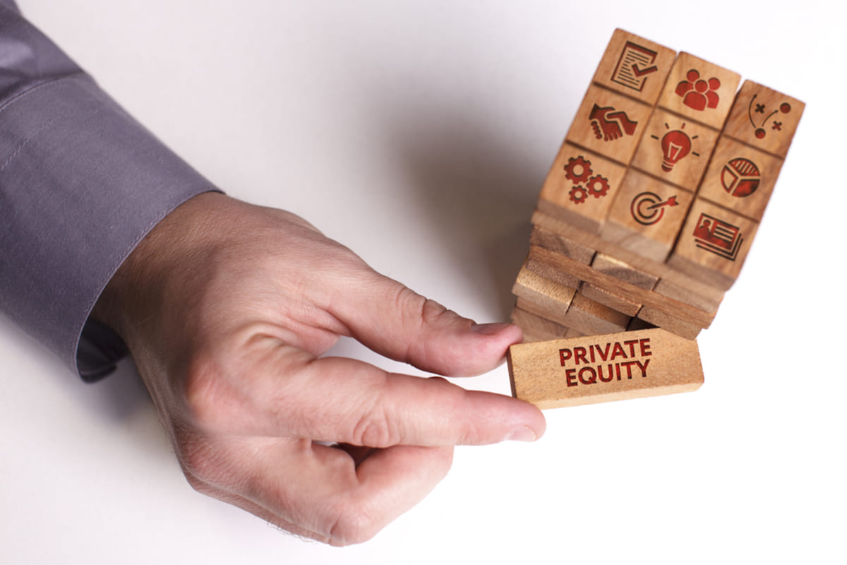 A businessman shows a business option with wooden blocks saying Private Equity.