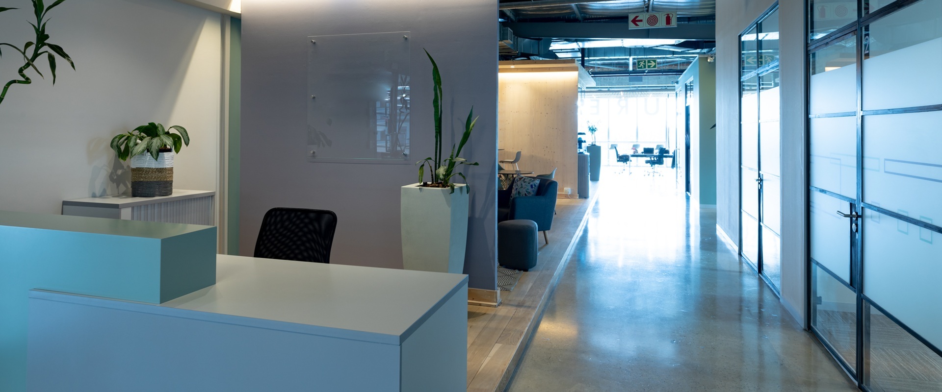 Empty chair at reception counter in modern illuminated office