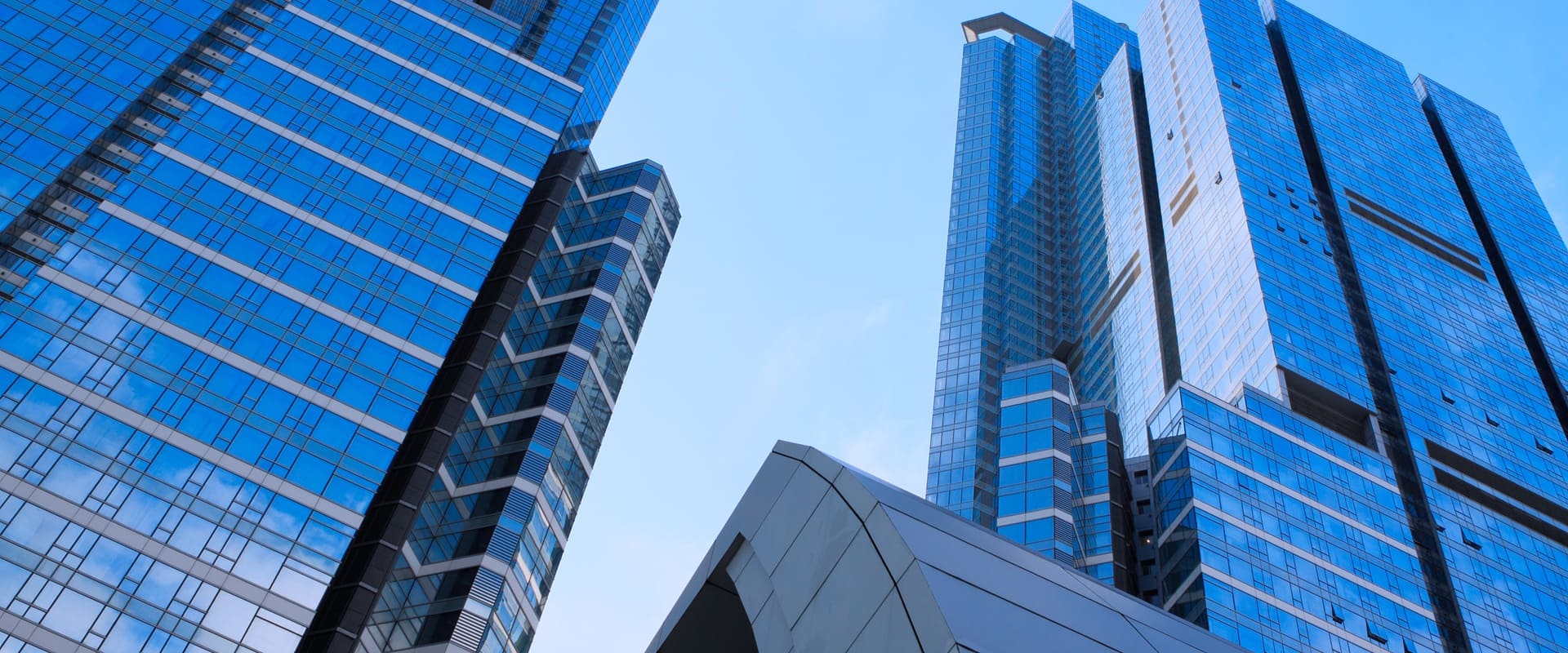 Modern Blue Skyscrapers Against Bright Sky