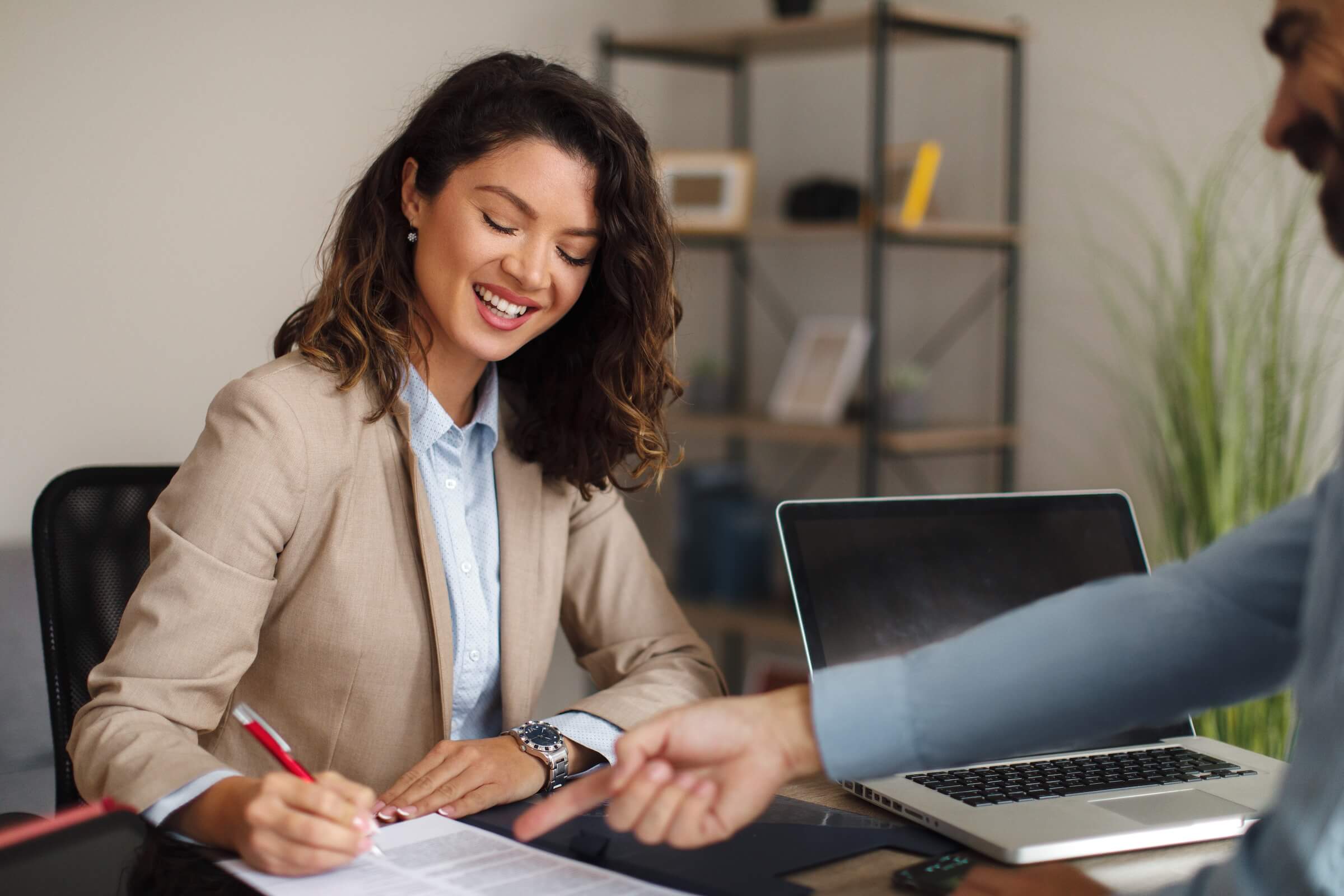 Young female professional signing a commercial letter of intent document
