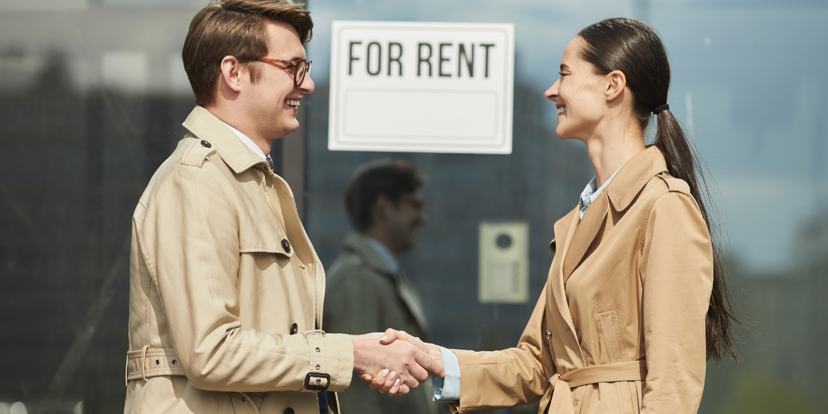 03 Business Agreement Man and Woman Shaking Hands Outdoors