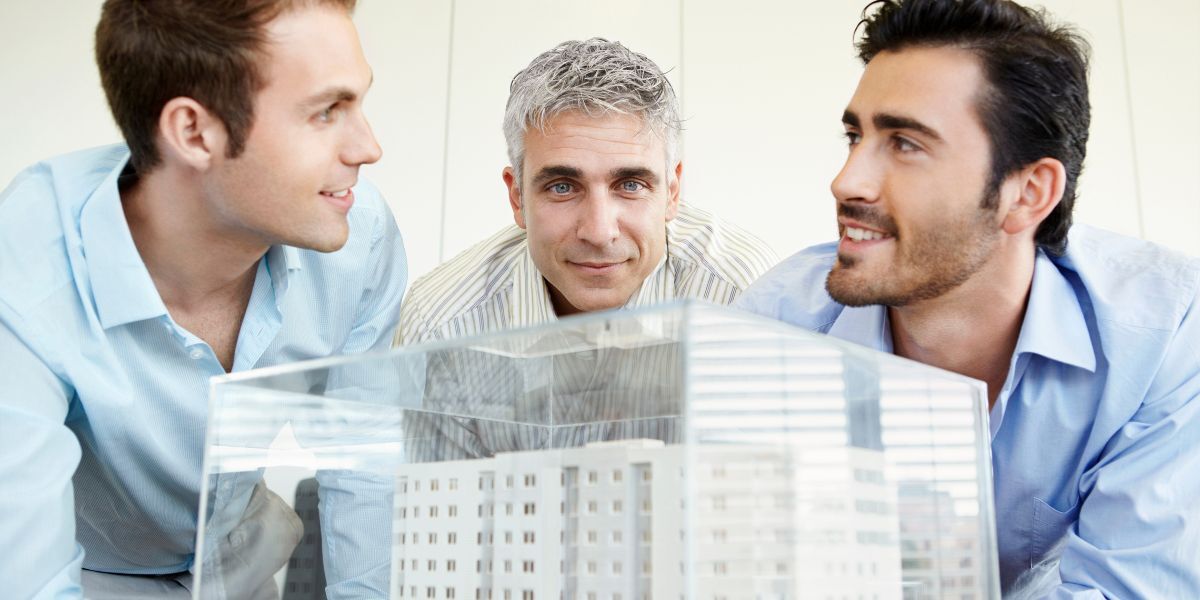 08 Architects Reviewing Model Building Construction in Office