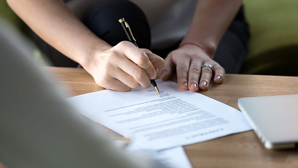 Close-up of signing a commercial lease agreement. 