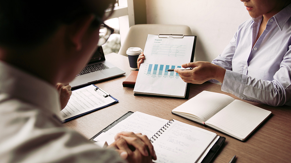 People reviewing financials from prospective commercial tenants.